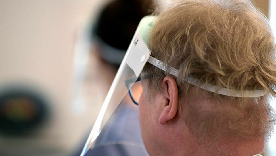En person med visir, utan munskydd. Foto: Janerik Henriksson/TT